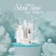 Skin care products for men displayed on a blue platform with water splash effect and marble-textured background.
