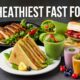 Healthiest fast food: Grilled chicken club sandwich, fresh veggie wraps, smoothies, and grilled chicken salad on a plate.
