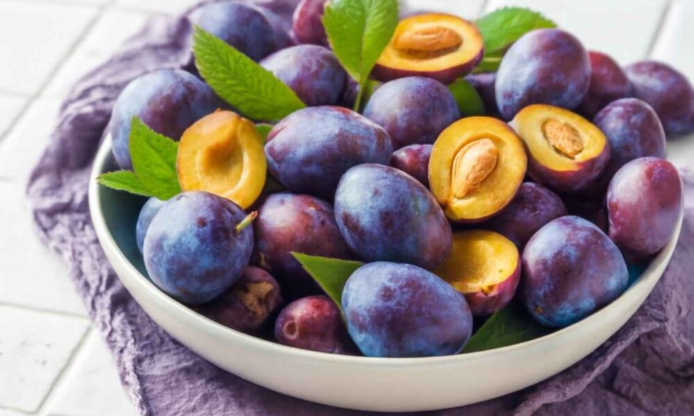 A bowl filled with fresh plums, showcasing the vibrant colors and highlighting the plum benefits for health