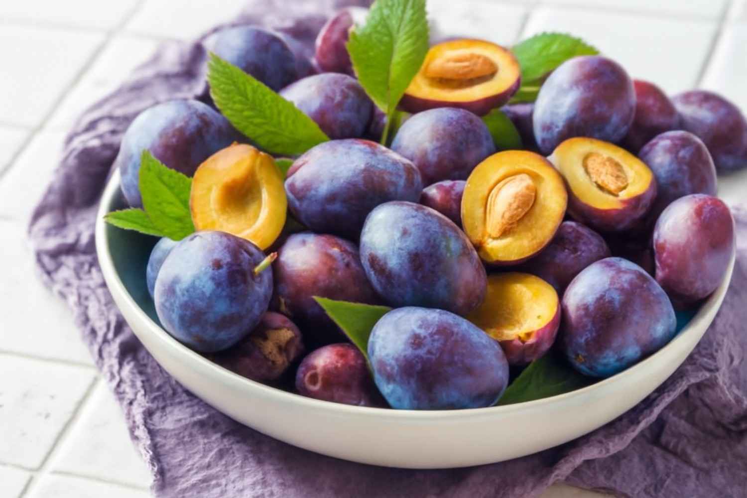 A bowl filled with fresh plums, showcasing the vibrant colors and highlighting the plum benefits for health